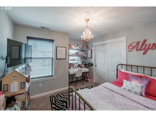 a bedroom with a bed and a chandelier