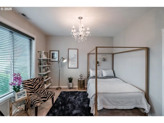 a bedroom with a bed and a chandelier