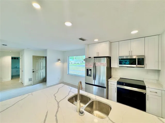 a bathroom with a shower and a sink a mirror