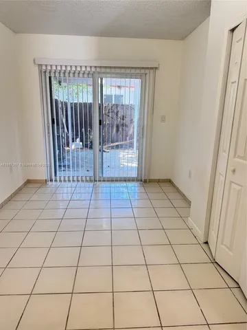 a view of a backyard with wooden fence