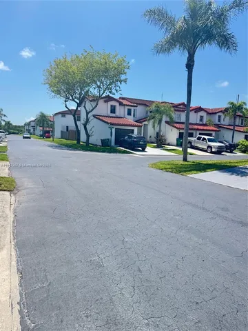 a view of a house with pool and a yard