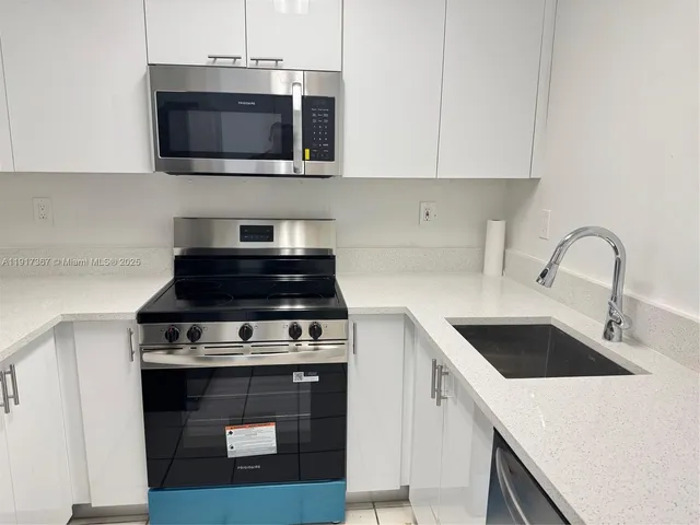 a kitchen with a stove a microwave and a counter top space