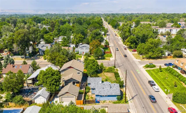 an aerial view of residential houses with outdoor space and swimming pool