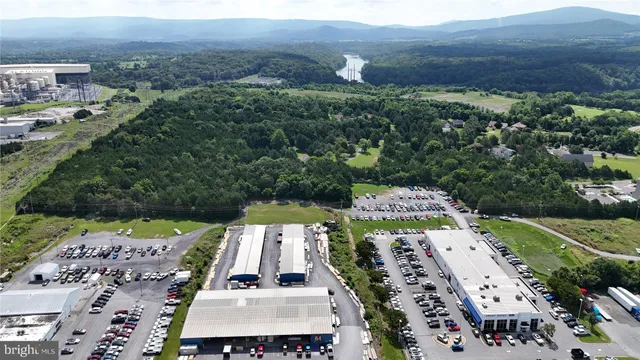 an aerial view of a house with a yard and lake view