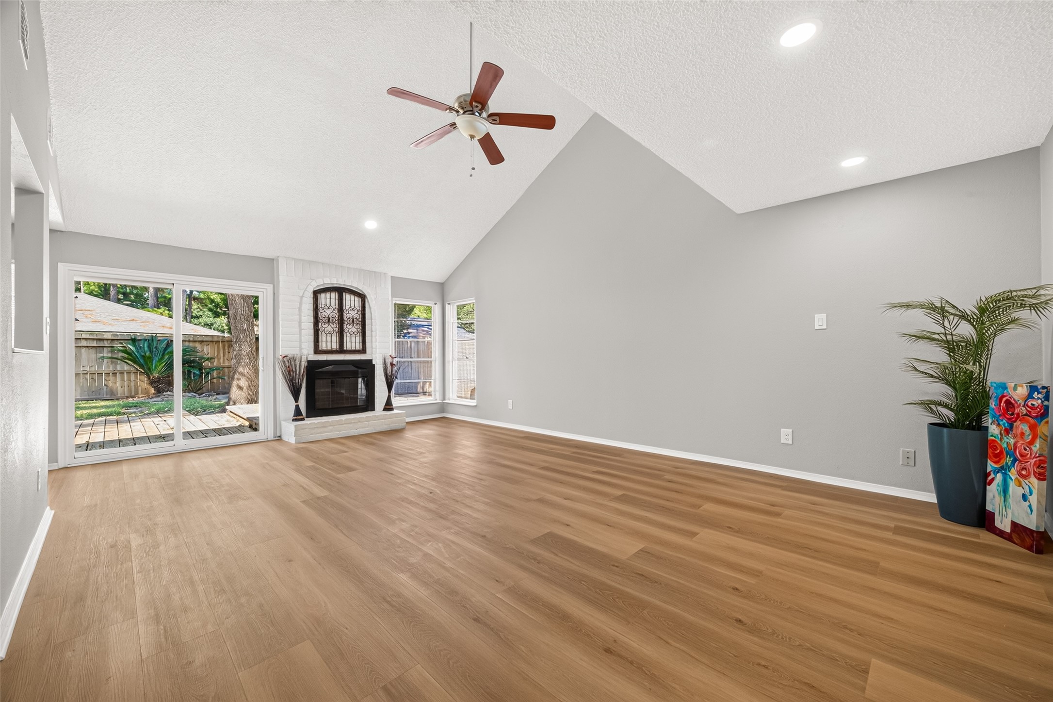23219 Calico Corners Lane Spring, TX 77373 - Photo 10 of 24 Living room with large windows and sliding glass doors offer abundant natural light and access to your private backyard.