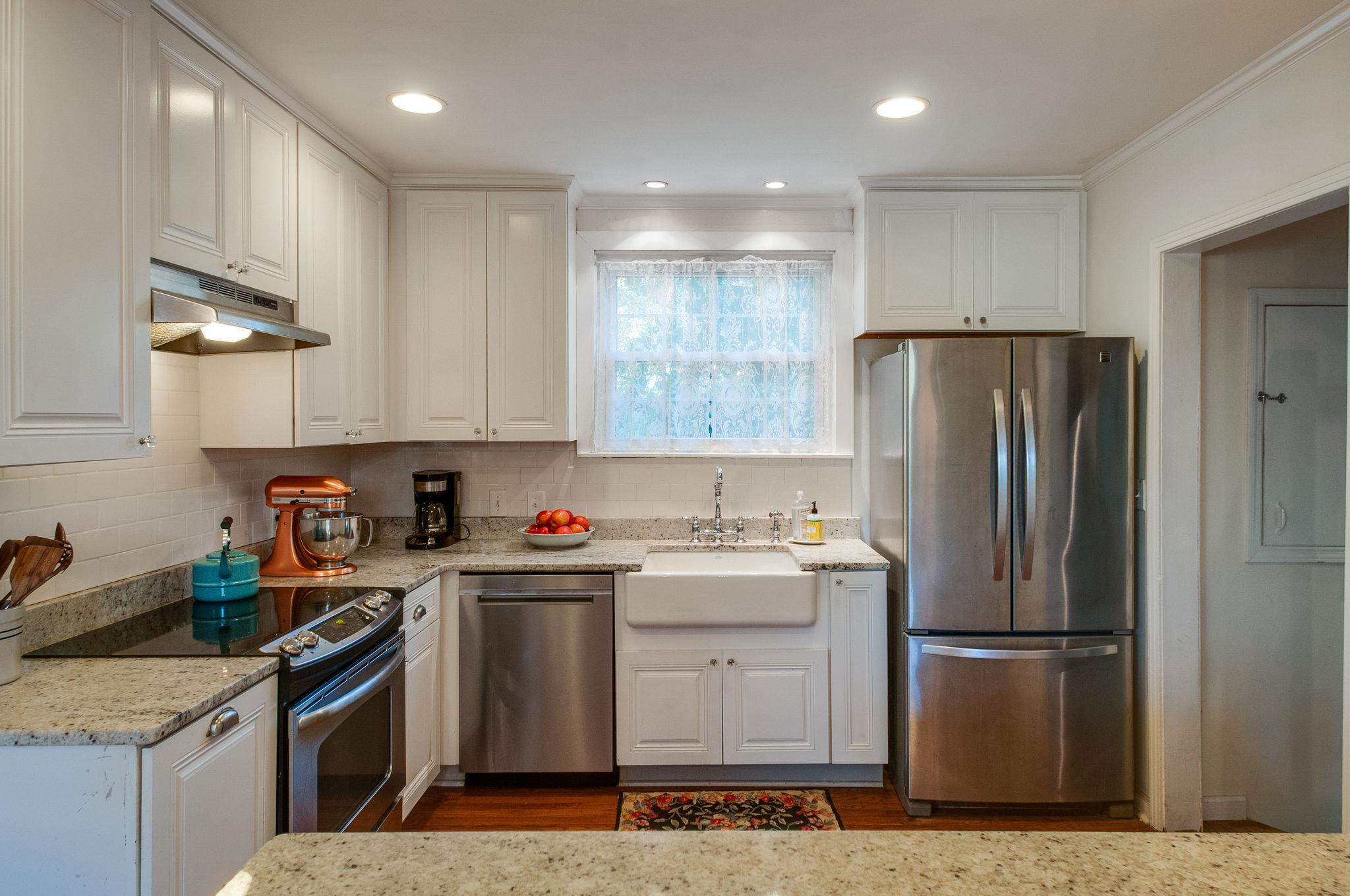 521 Hogan Road Nashville, TN 37220 - Photo 7 of 27 Kitchen with granite + tiled backsplash + farmhouse sink