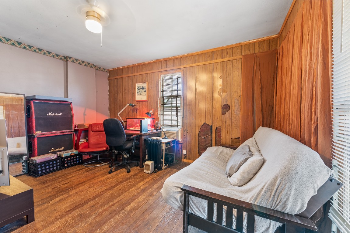 1001 Catalpa Street Austin, TX 78702 - Photo 7 of 10 a bedroom with a bed and wooden floor