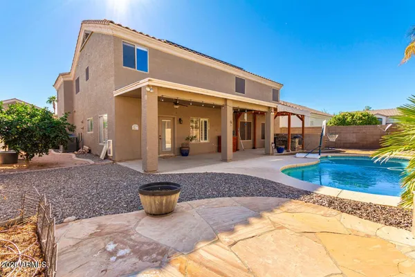 a view of a house with backyard and sitting area