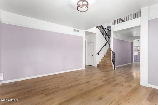 a view of a kitchen with a sink and wooden floor