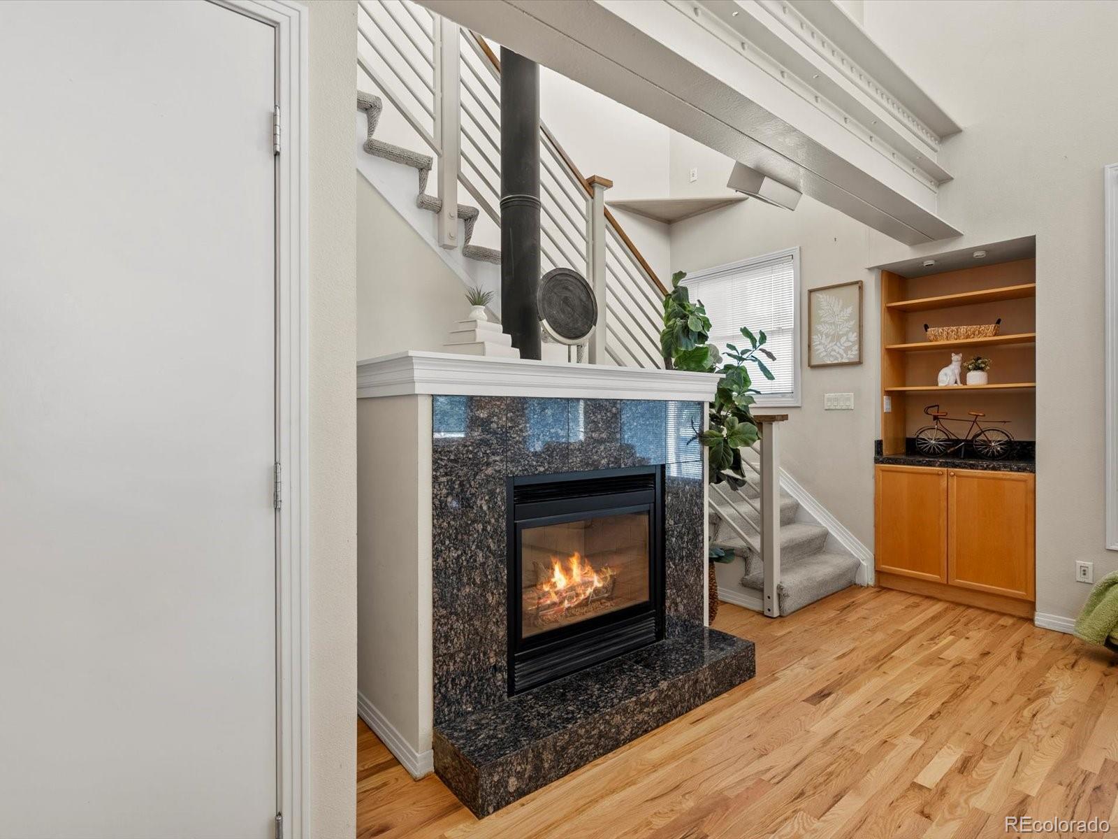 225 Lincoln Street, Unit 4 Denver, CO 80203 - Photo 11 of 34 a view of an empty room with wooden floor fireplace and a window