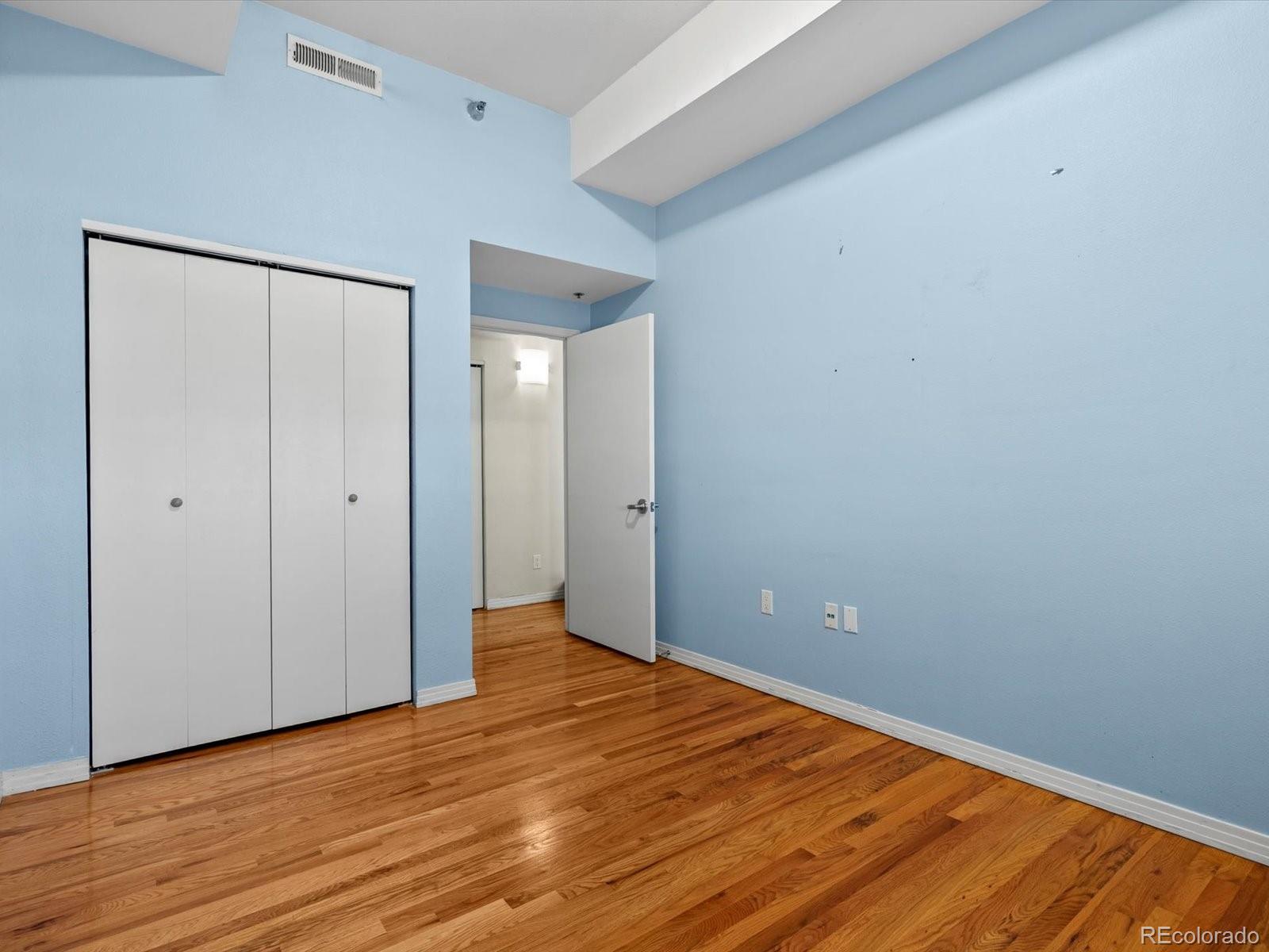 225 Lincoln Street, Unit 4 Denver, CO 80203 - Photo 12 of 34 a view of an empty room with wooden floor