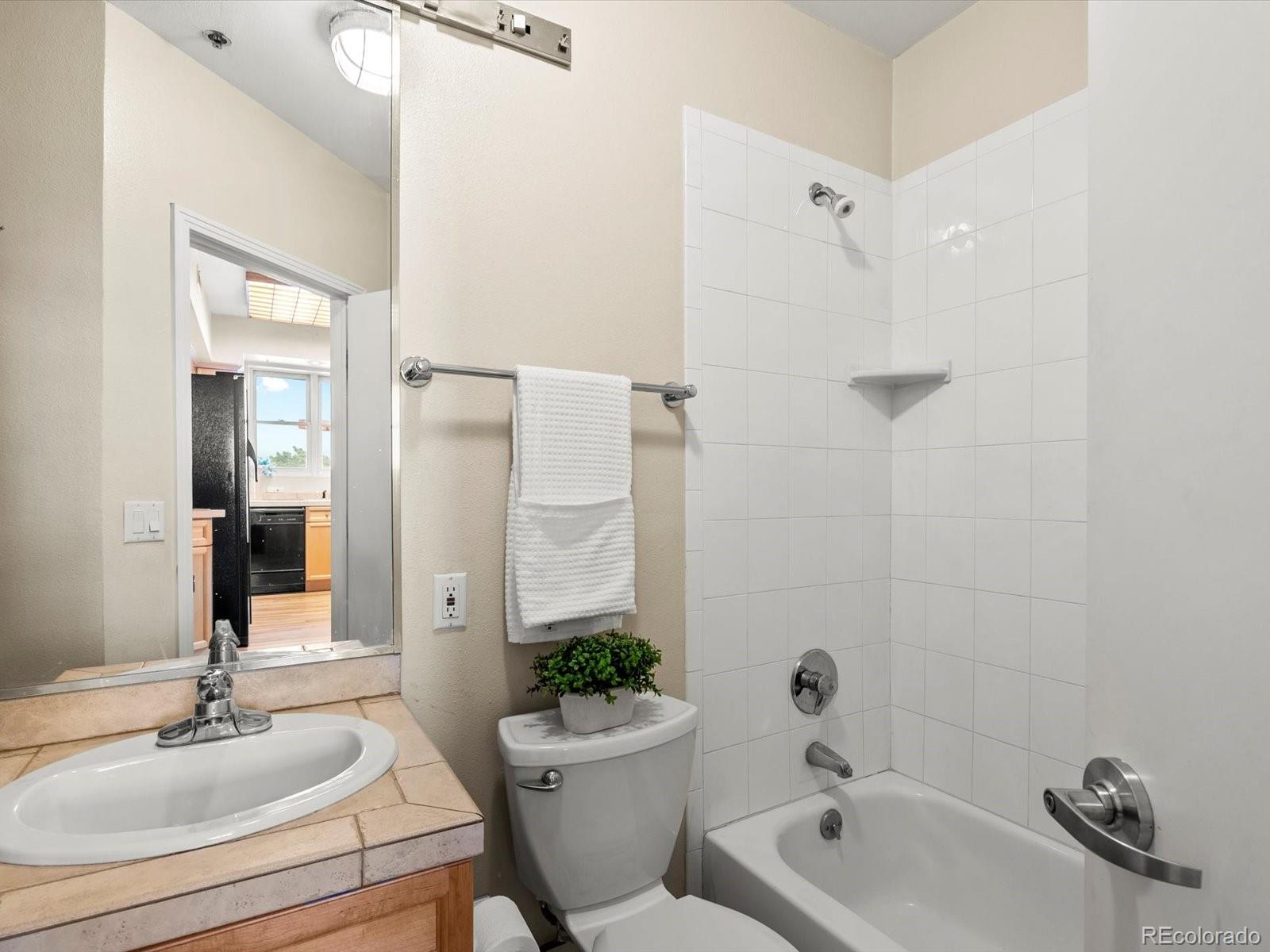 225 Lincoln Street, Unit 4 Denver, CO 80203 - Photo 14 of 34 a bathroom with a tub a sink and mirror