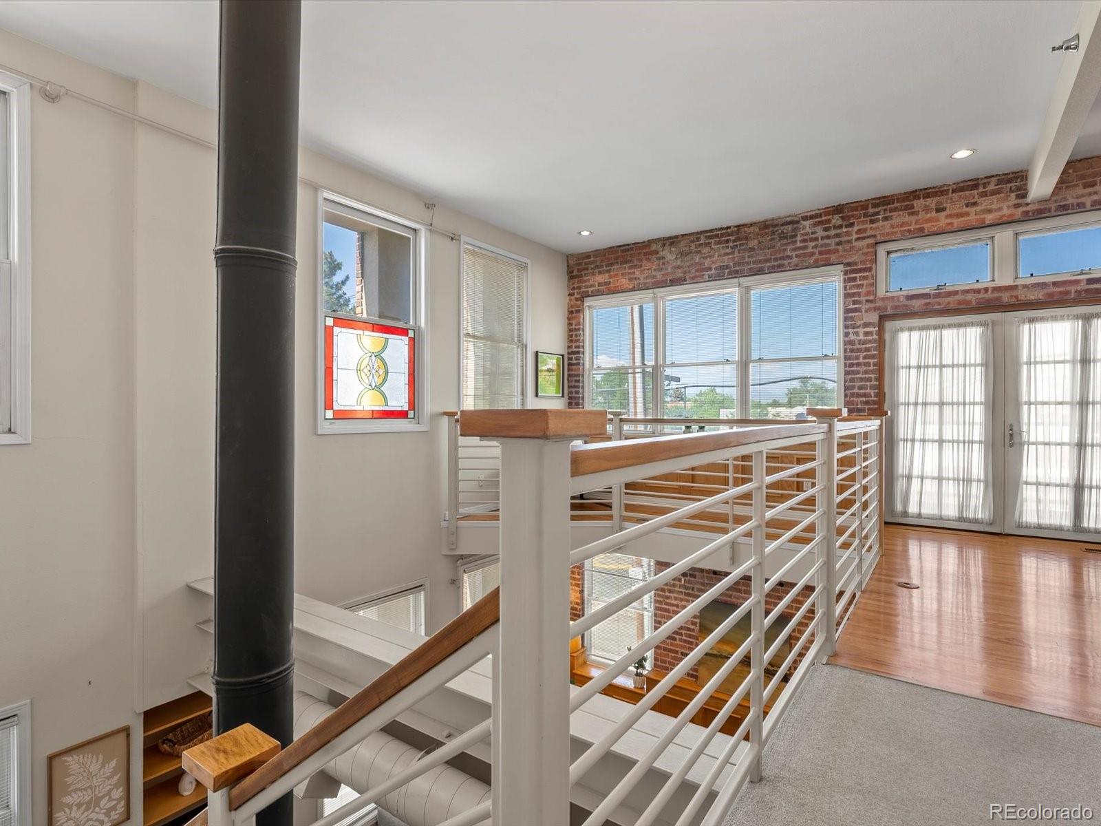 225 Lincoln Street, Unit 4 Denver, CO 80203 - Photo 16 of 34 a room with wooden floor and windows