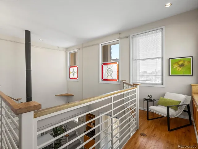 a work room with furniture and a wooden floor