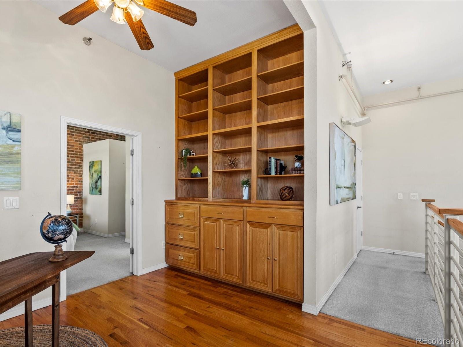225 Lincoln Street, Unit 4 Denver, CO 80203 - Photo 21 of 34 a bedroom with a bed and a chandelier