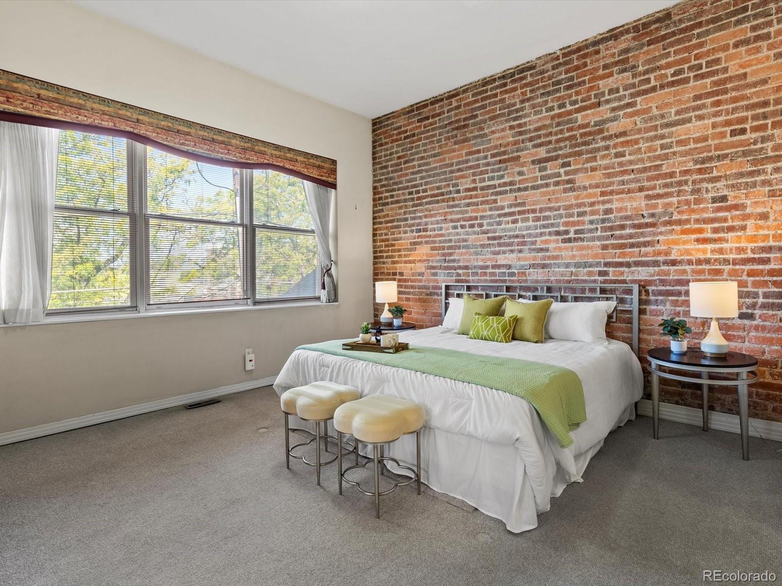 225 Lincoln Street, Unit 4 Denver, CO 80203 - Photo 23 of 34 a bed sitting in a bedroom next to a window