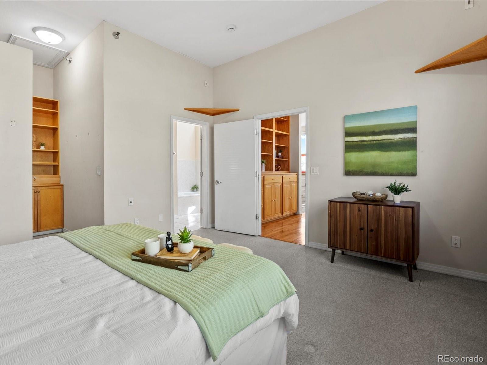 225 Lincoln Street, Unit 4 Denver, CO 80203 - Photo 24 of 34 a bedroom with a bed and a flat screen tv