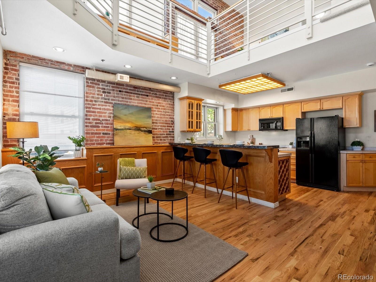 225 Lincoln Street, Unit 4 Denver, CO 80203 - Photo 4 of 34 a living room with stainless steel appliances kitchen island granite countertop furniture and a large window