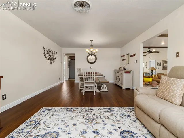 a view of a dining room with furniture and wooden floor
