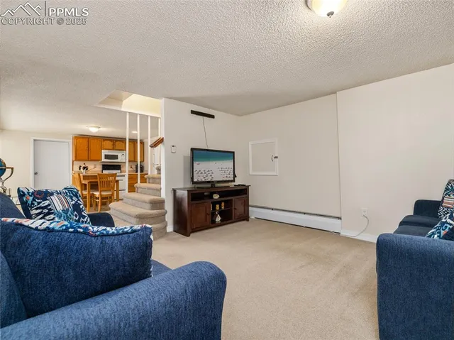 a bedroom with a large bed and a ceiling fan