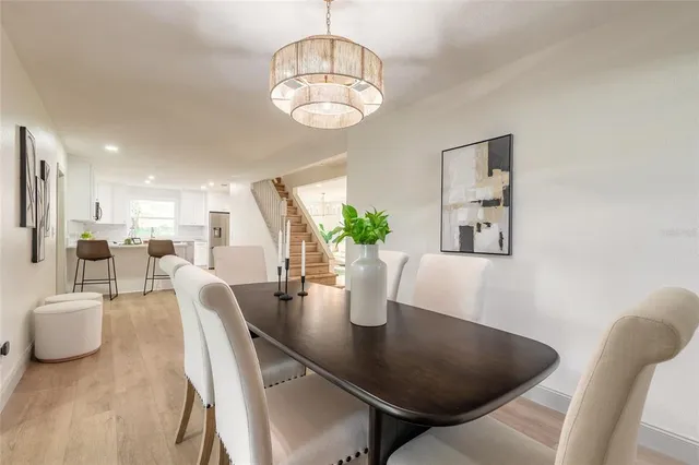 a view of a dining room with furniture and chandelier