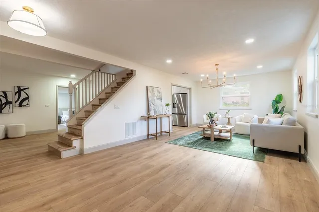 a living room with furniture and wooden floor