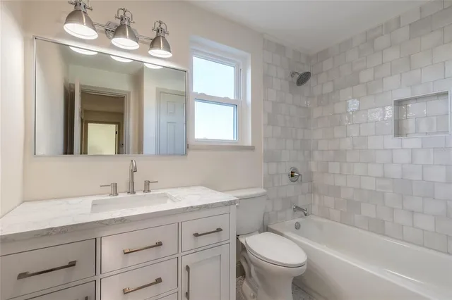 an empty room with wooden floor and window