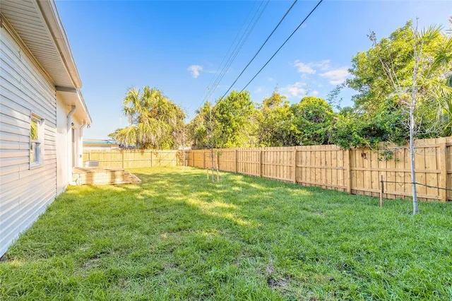 an aerial view of residential houses with outdoor space and ocean view
