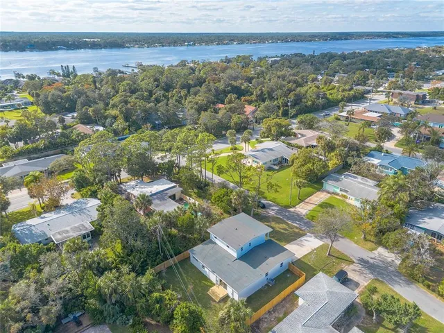 an aerial view of residential houses with outdoor space