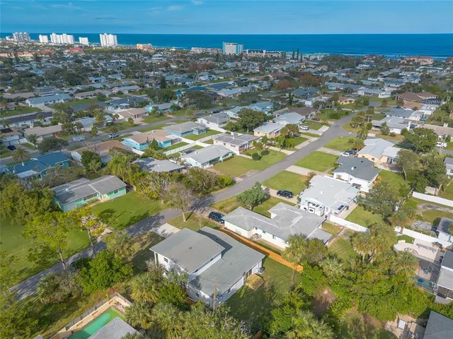 an aerial view of residential houses with outdoor space