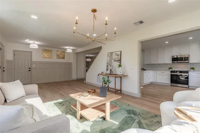 a living room with furniture and kitchen view