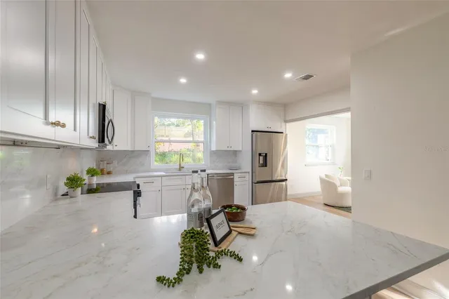 a kitchen with refrigerator and cabinets