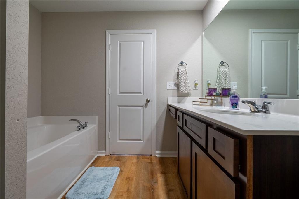 735 Walnut Creek Circle Pendergrass, GA 30567 - Photo 22 of 29 a bathroom with a tub sink and mirror