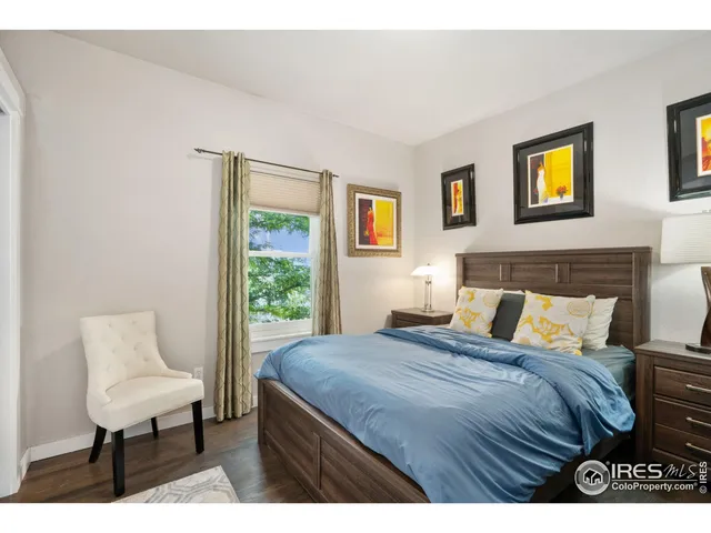 a bedroom with a bed and a lamp on table