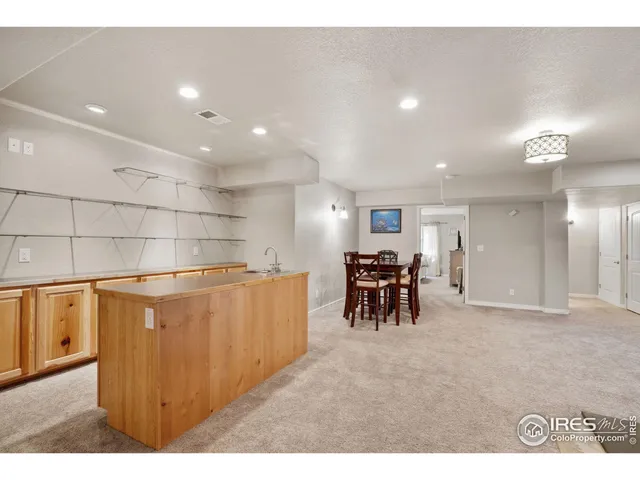 a view of kitchen with furniture and a refrigerator