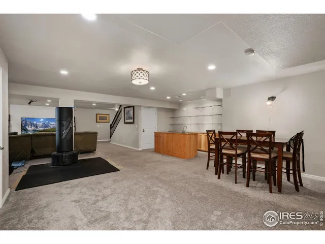 a open kitchen with kitchen island a sink table and chairs