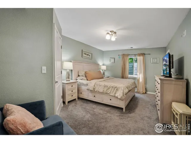 a bedroom with a bed and a view of living room