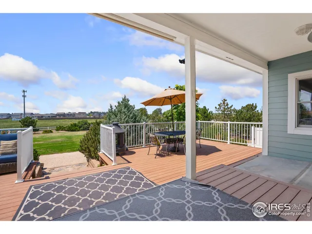 a view of a deck with a floor to ceiling window next to a yard