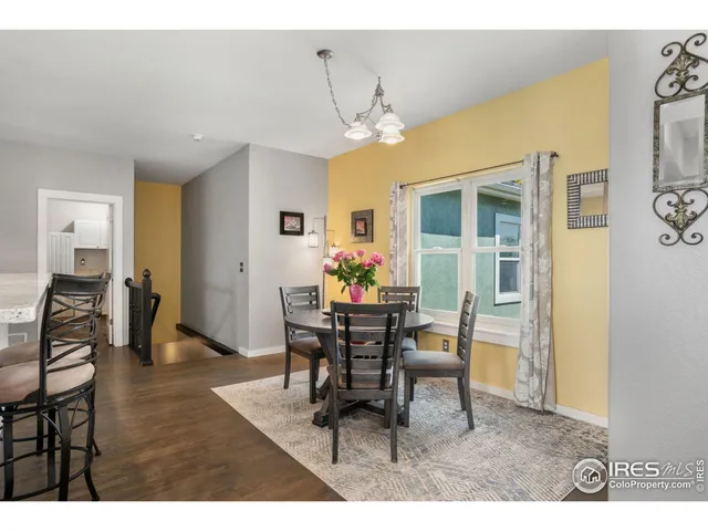 a dining room with furniture a chandelier and wooden floor
