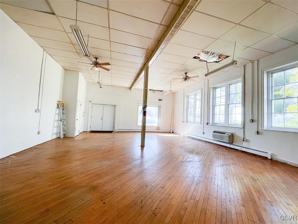 4111 Mauch Chunk Road Coplay, PA 18037 - Photo 12 of 43 an empty room with wooden floor and windows