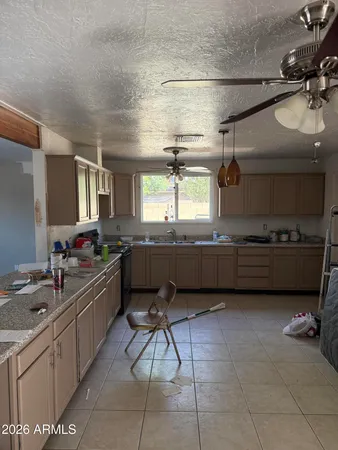 a kitchen with a sink a counter top space appliances and cabinets