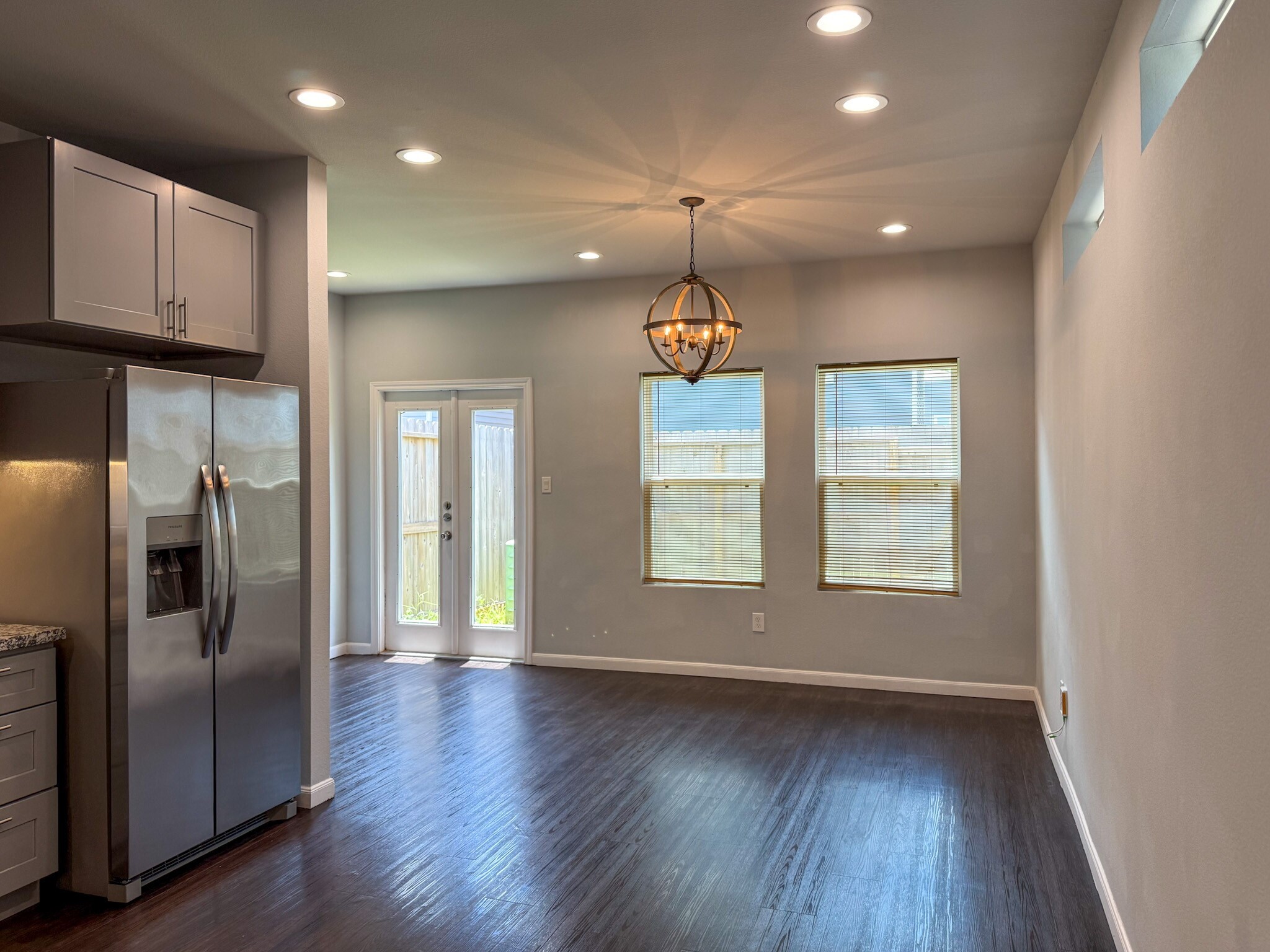 4939 Ambient Dr Spring Spring, TX 77379 - Photo 2 of 18 a view of an empty room with wooden floor and a window