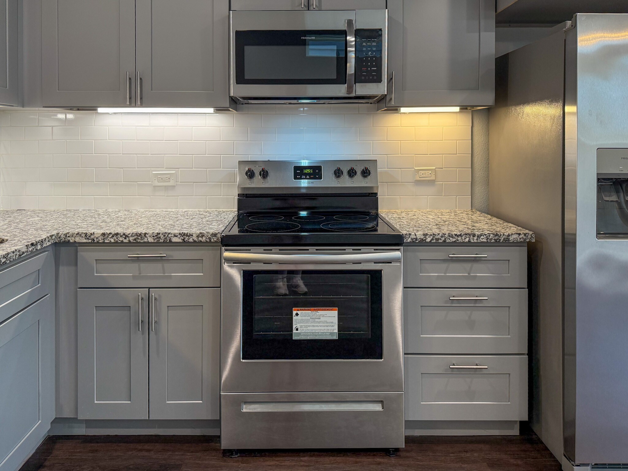 4939 Ambient Dr Spring Spring, TX 77379 - Photo 5 of 18 a kitchen with granite countertop stainless steel appliances and white cabinets