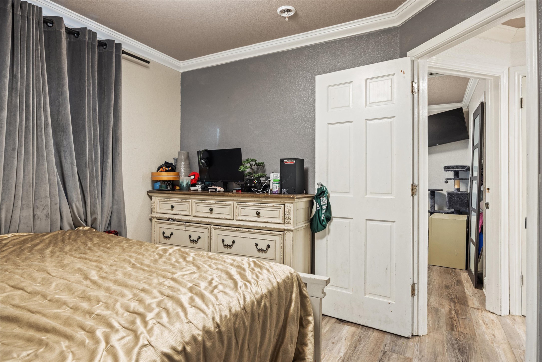 14409 Sandifer Street Austin, TX 78725 - Photo 17 of 31 Bedroom with crown molding and light wood finished floors