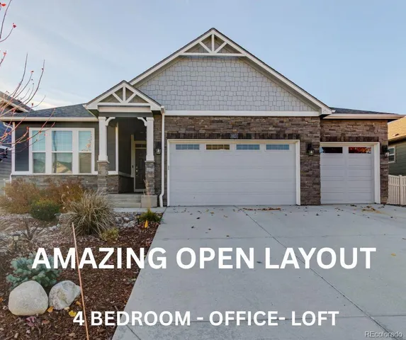 a kitchen with stainless steel appliances granite countertop a kitchen island hardwood floor and a sink
