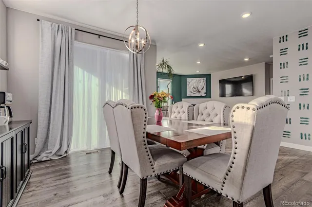 a view of a dining room with furniture and wooden floor