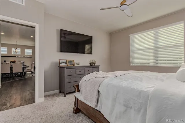 a bathroom with a double vanity sink a toilet a mirror and shower