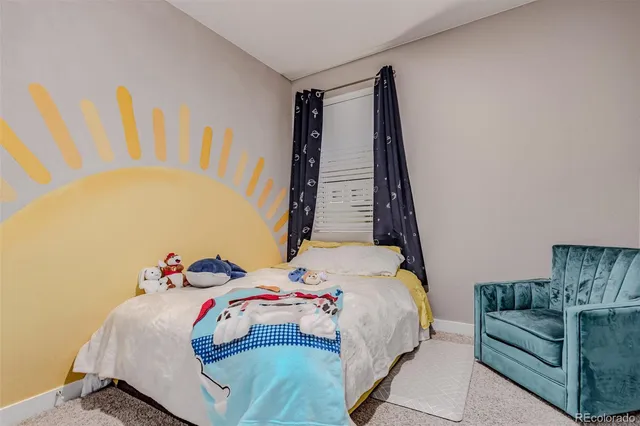 a bedroom with furniture and a window