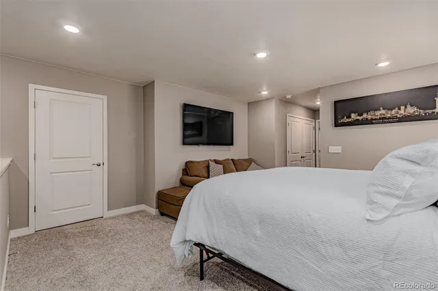 a bedroom with a bed and a desk