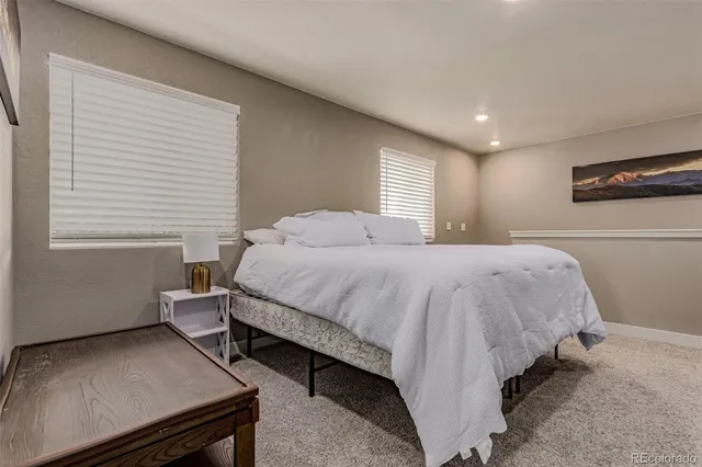 a bedroom with a bed and a couch